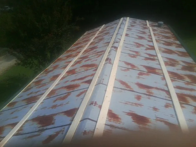 Rusted metal roof panels with new wood purlins before replacement — Storm Damage Roof Repair in Dallastown by Roofing Brothers