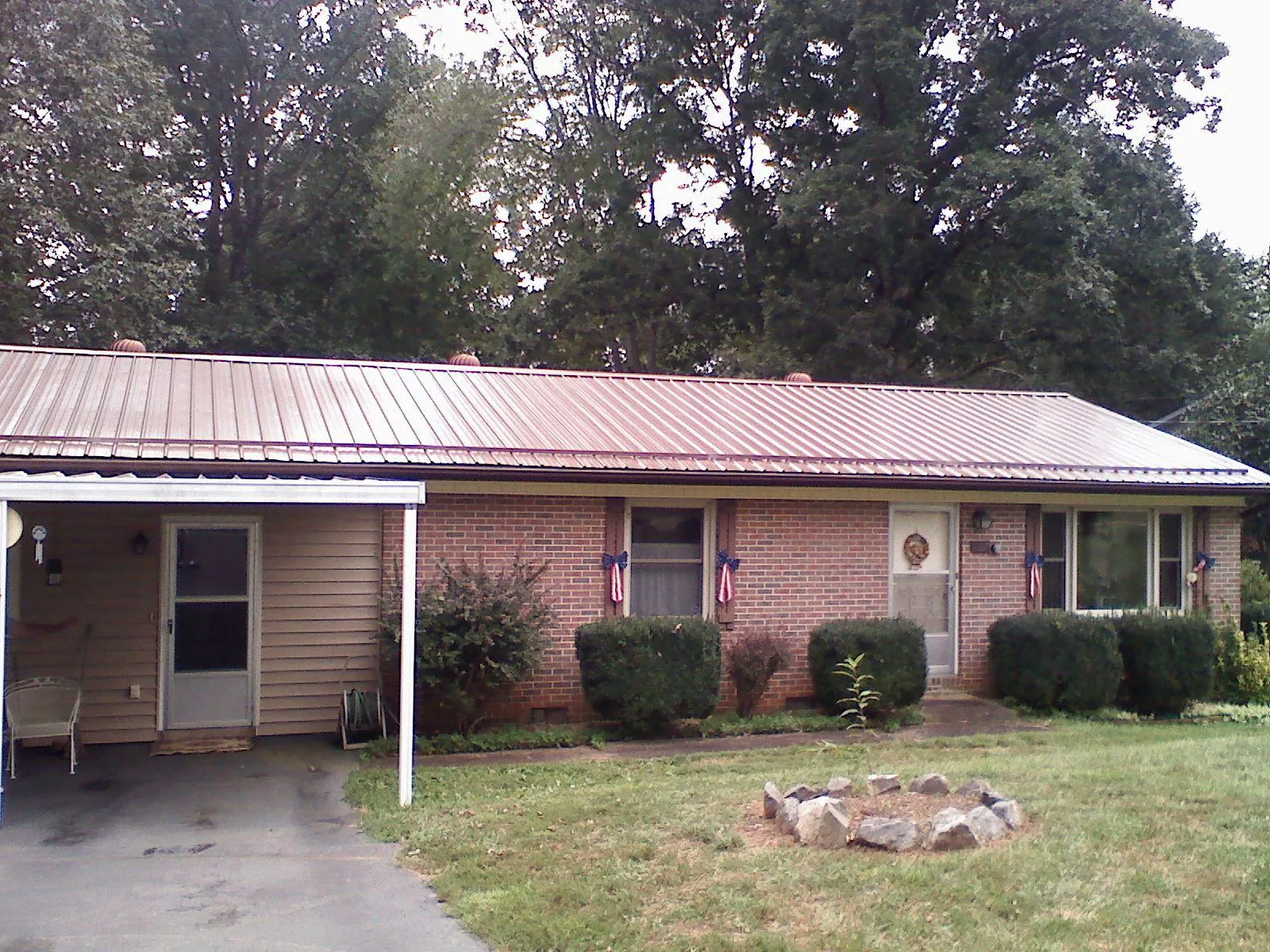 Bronze metal roof and carport on a brick ranch home — Roof Repair work by our crew in Dallastown